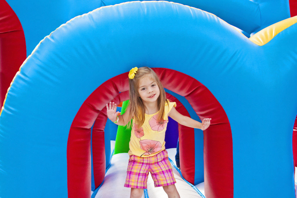 kid playing in the inflatable playground