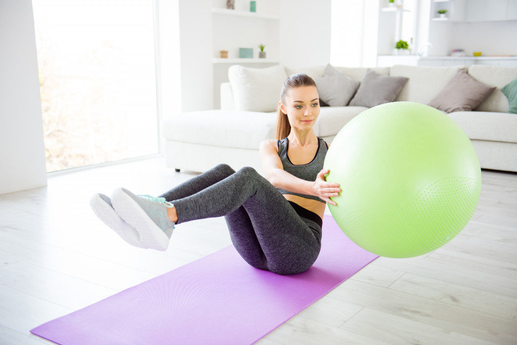 woman using a gym ball to exercise