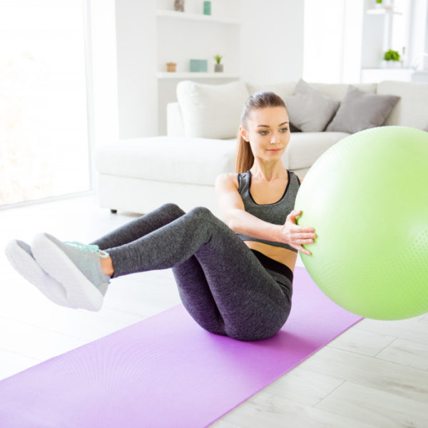 woman using a gym ball to exercise